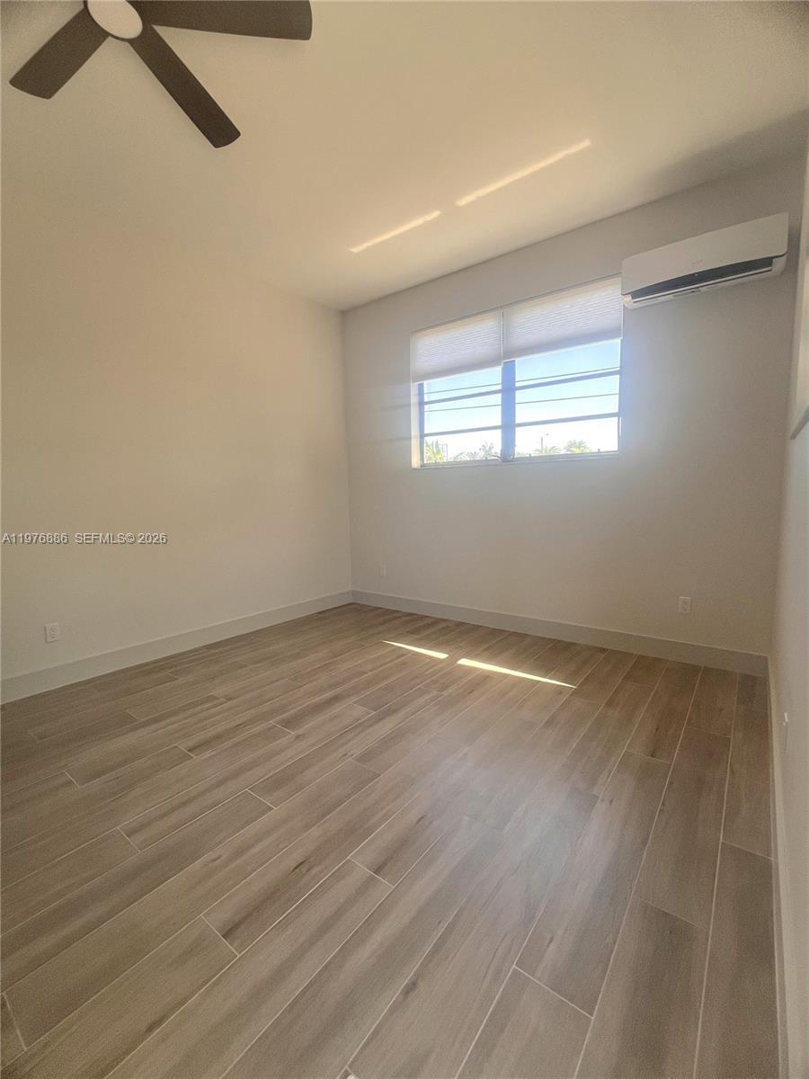 7760 Southwest 20th Street, Unit 1 Miami, FL 33155 - Photo 3 of 7 wooden floor in an empty room with a window
