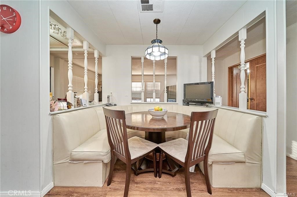 2601 East Victoria Street, Unit 394 Rancho Dominguez, CA 90220 - Photo 11 of 19 a dining room with furniture a chandelier and window