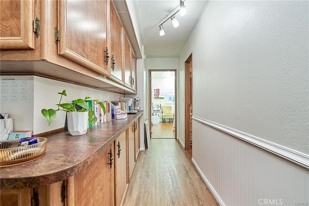 2601 East Victoria Street, Unit 394 Rancho Dominguez, CA 90220 - Photo 15 of 19 a dining room with furniture potted plants and wooden floor