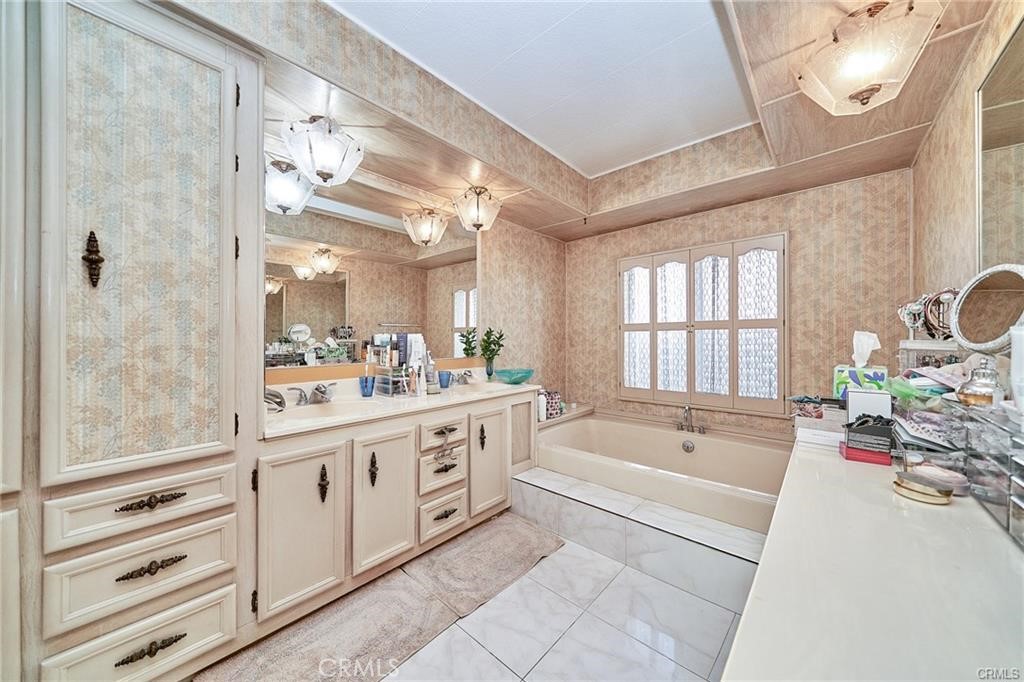 2601 East Victoria Street, Unit 394 Rancho Dominguez, CA 90220 - Photo 16 of 19 a spacious bathroom with a tub sink and mirror