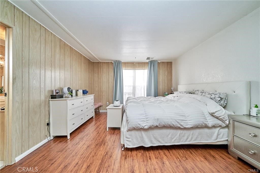 2601 East Victoria Street, Unit 394 Rancho Dominguez, CA 90220 - Photo 17 of 19 a spacious bedroom with a bed and a dresser