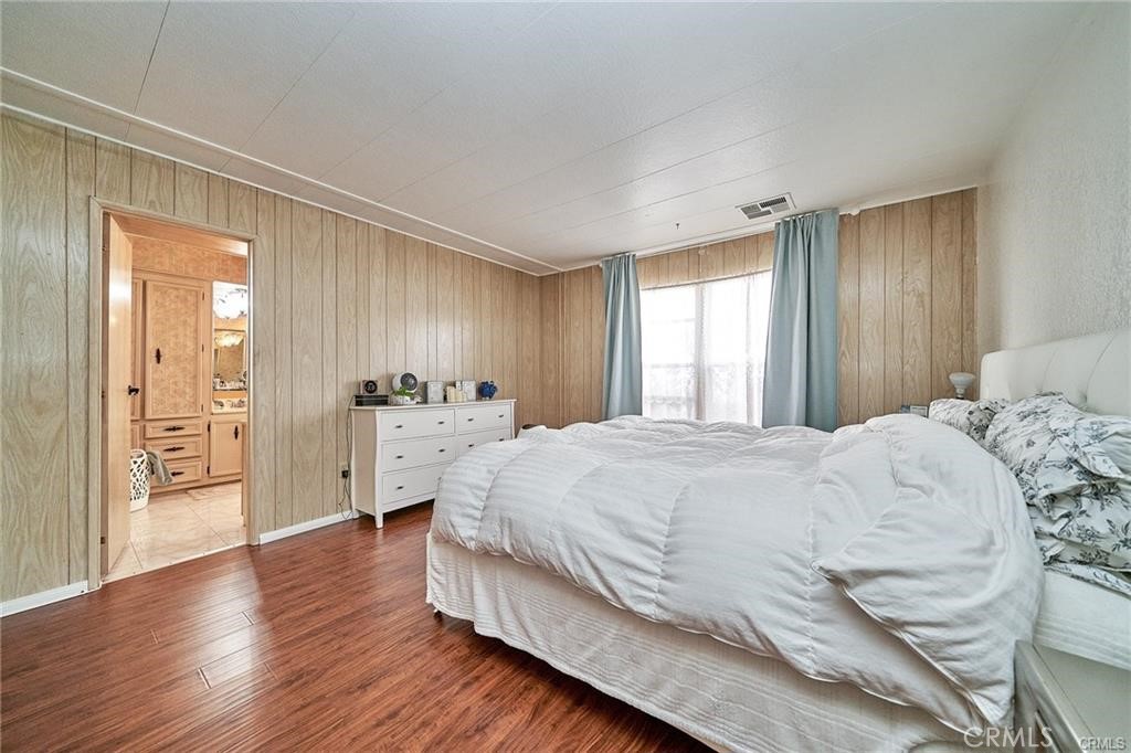 2601 East Victoria Street, Unit 394 Rancho Dominguez, CA 90220 - Photo 18 of 19 a spacious bedroom with a bed and a closet
