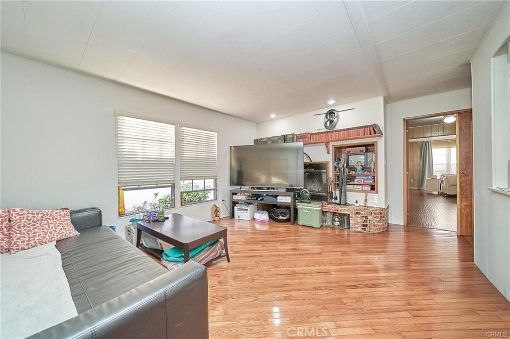 2601 East Victoria Street, Unit 394 Compton, CA 90220 - Photo 5 of 25 a living room with furniture large window and flat screen tv
