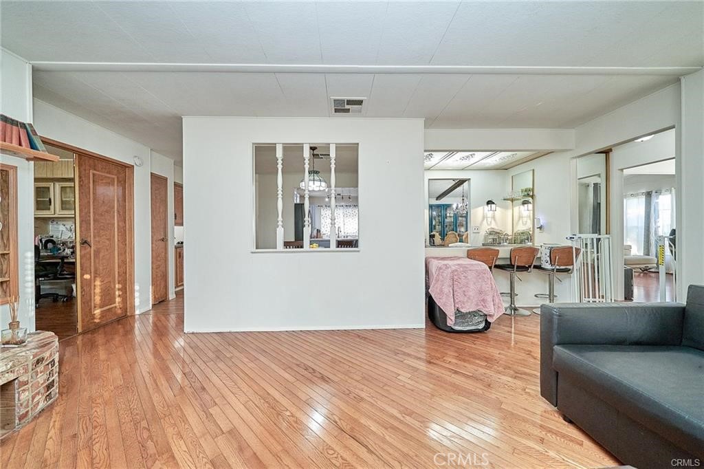 2601 East Victoria Street, Unit 394 Rancho Dominguez, CA 90220 - Photo 5 of 19 a living room with furniture and wooden floor
