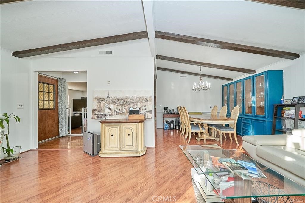 2601 East Victoria Street, Unit 394 Rancho Dominguez, CA 90220 - Photo 6 of 19 a living room with stainless steel appliances kitchen island granite countertop furniture and a kitchen view