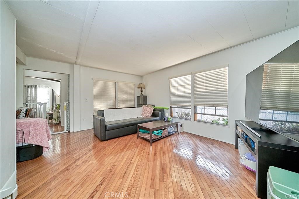 2601 East Victoria Street, Unit 394 Rancho Dominguez, CA 90220 - Photo 9 of 19 a living room with furniture and a wooden floor