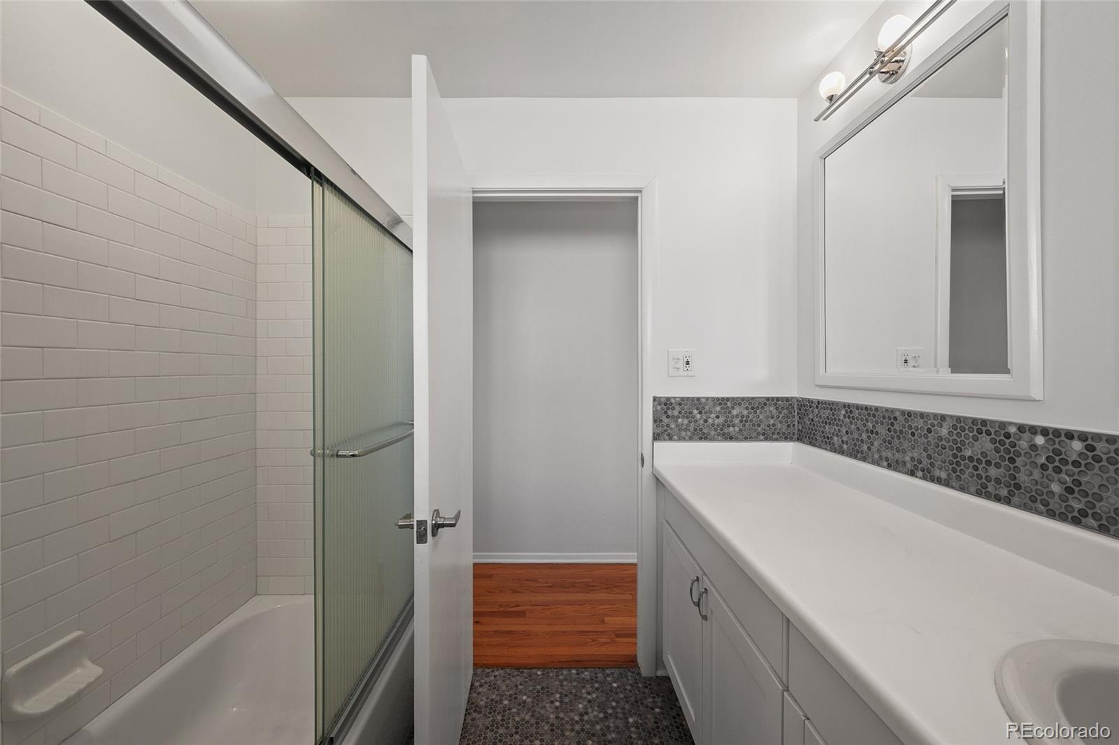 3045 Stuart Street Denver, CO 80212 - Photo 13 of 41 a bathroom with a bathtub and shower