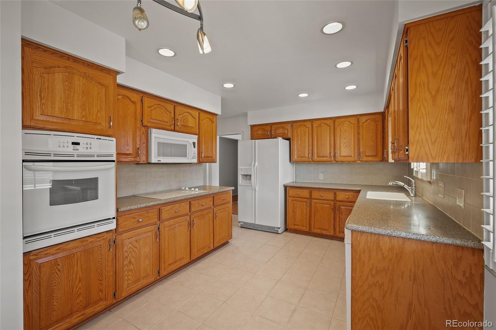 3045 Stuart Street Denver, CO 80212 - Photo 16 of 41 a large kitchen with stainless steel appliances granite countertop a sink a stove and a refrigerator