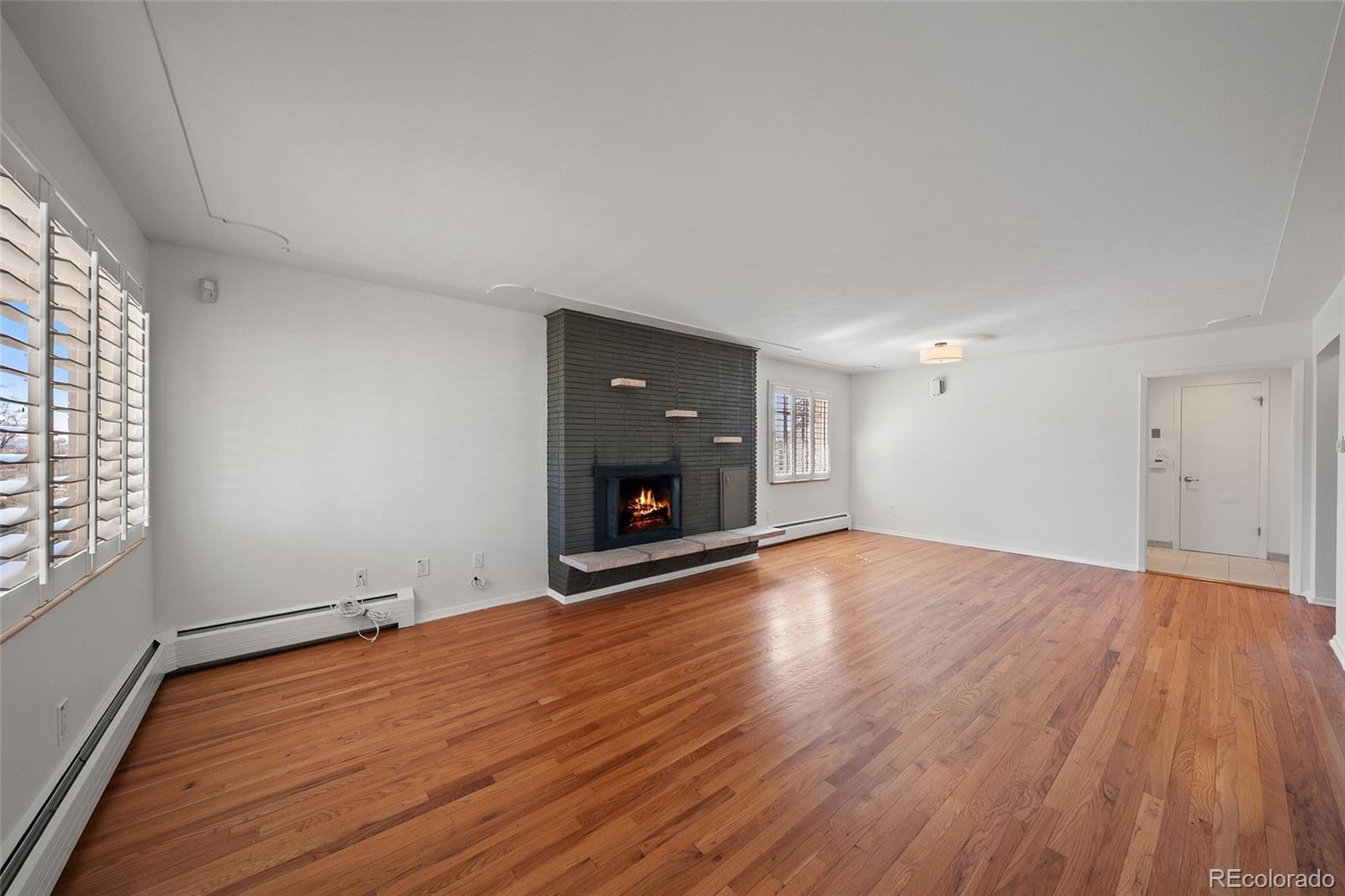 3045 Stuart Street Denver, CO 80212 - Photo 2 of 41 an empty room with wooden floor and a window