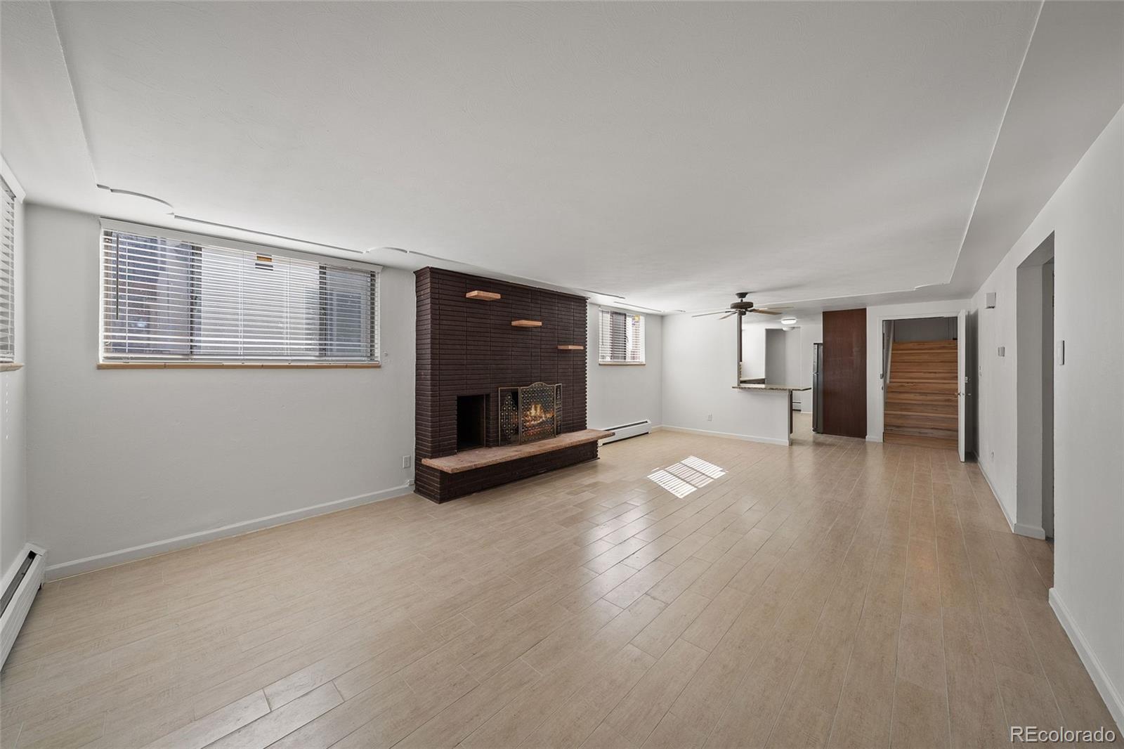 3045 Stuart Street Denver, CO 80212 - Photo 21 of 41 a view of empty room with wooden floor and fireplace