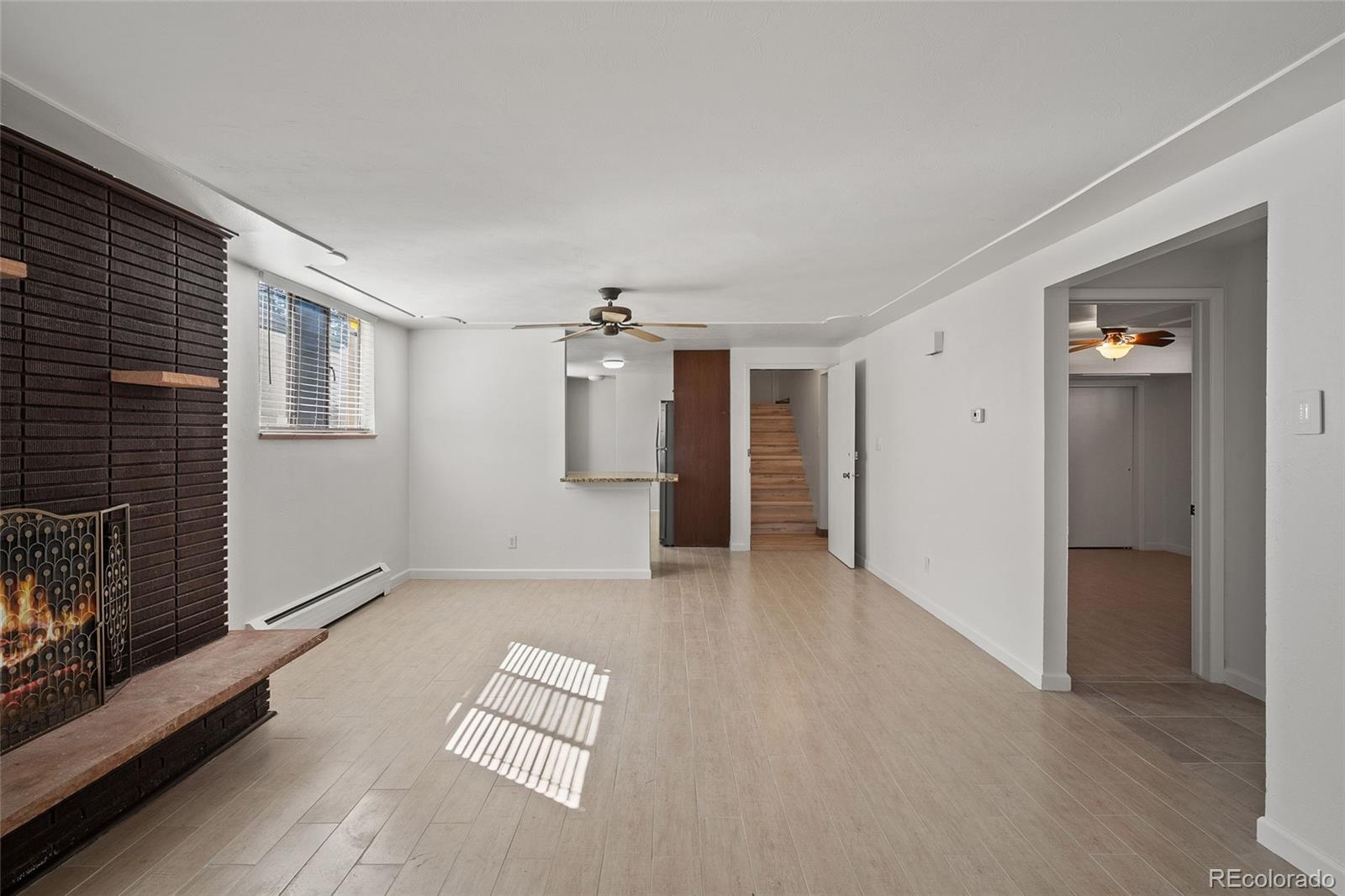 3045 Stuart Street Denver, CO 80212 - Photo 23 of 41 a view of empty room with wooden floor and fireplace