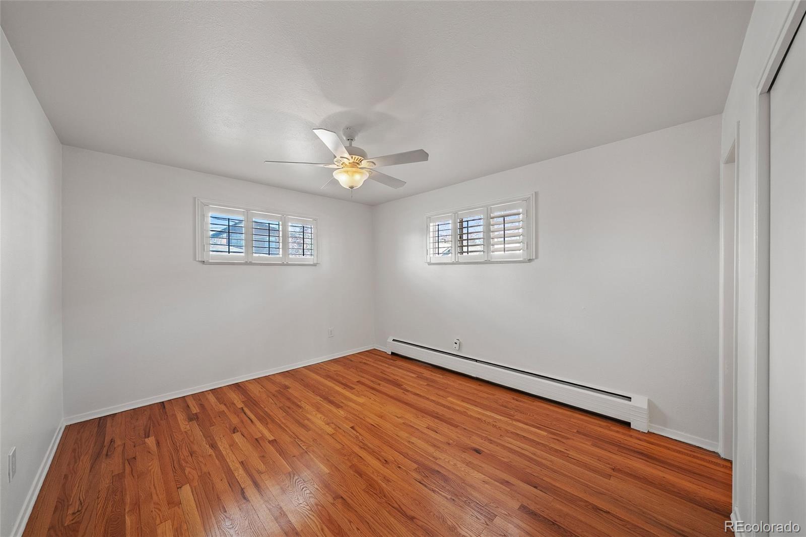 3045 Stuart Street Denver, CO 80212 - Photo 6 of 41 a view of an empty room with wooden floor and a window