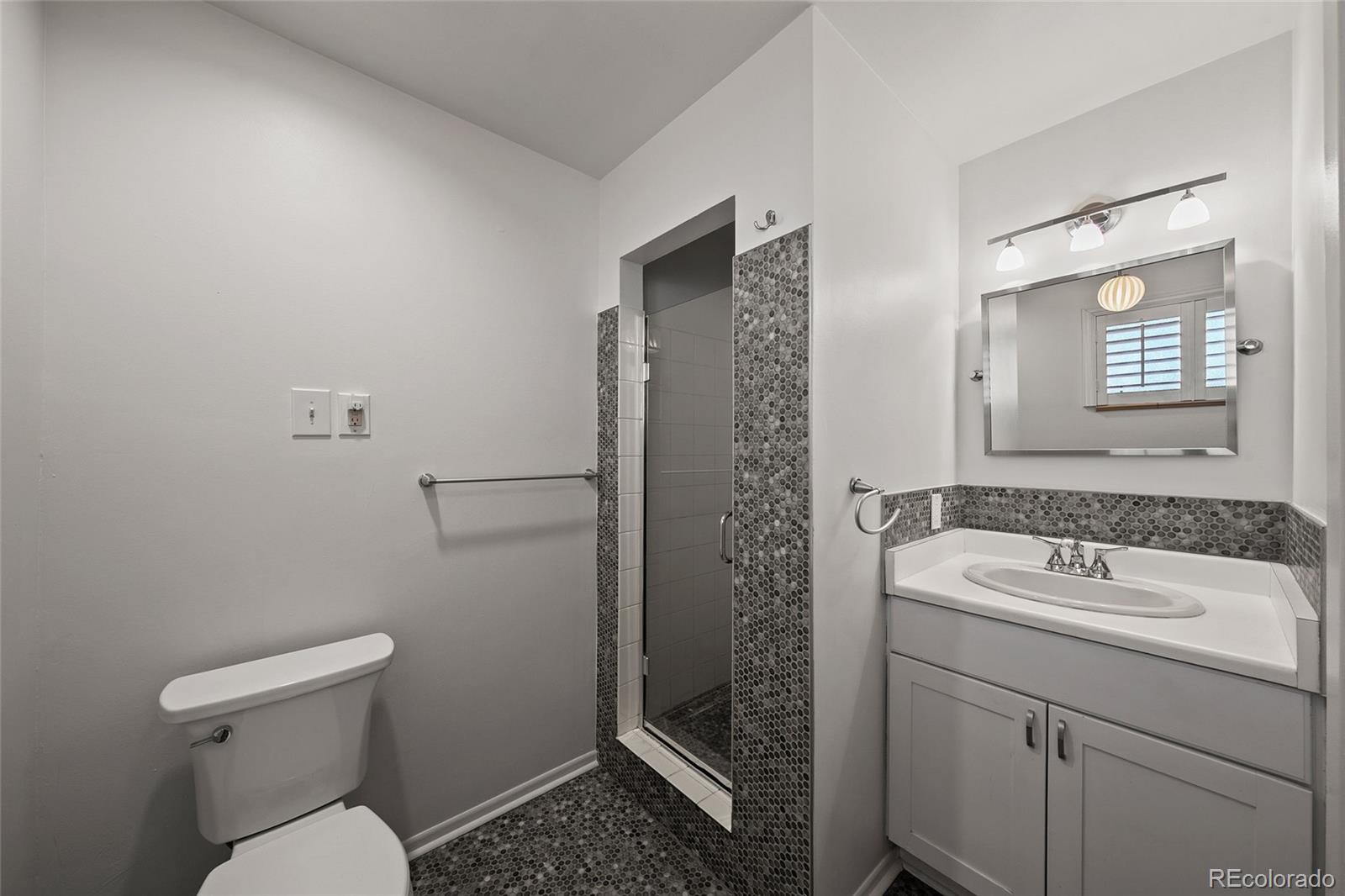 3045 Stuart Street Denver, CO 80212 - Photo 9 of 41 a bathroom with a sink toilet and shower