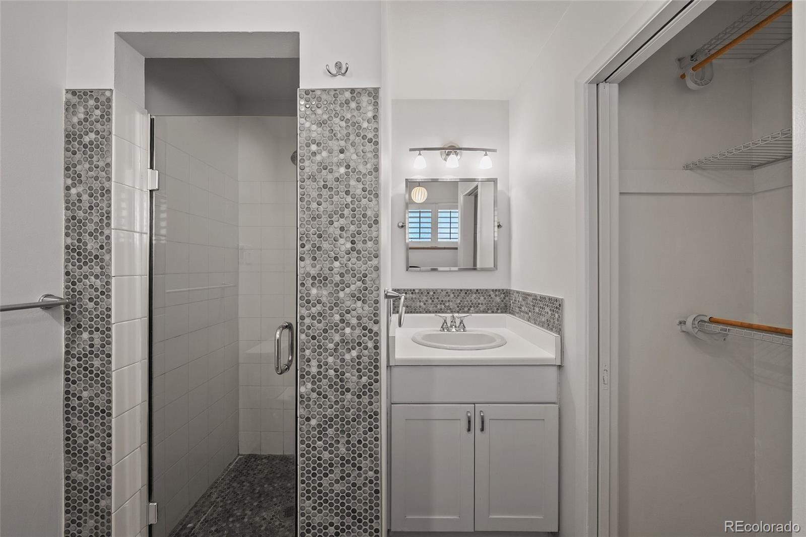 3045 Stuart Street Denver, CO 80212 - Photo 10 of 41 a bathroom with a sink a mirror and shower