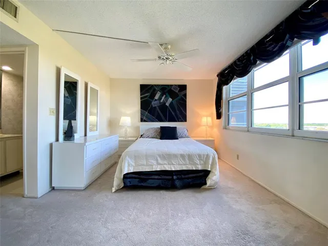 a bed room with a bed and a chandelier