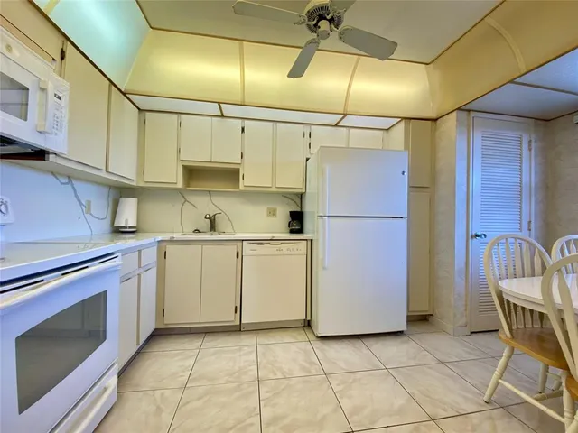 a kitchen with cabinets and stainless steel appliances