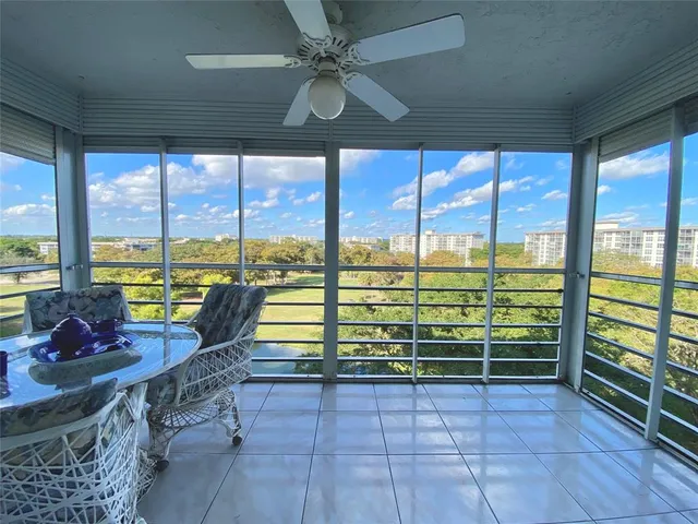 a living room with furniture and large windows