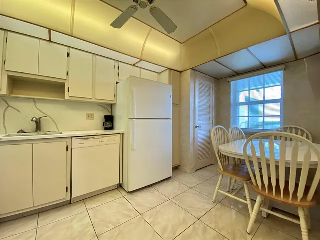 a kitchen with table and chairs