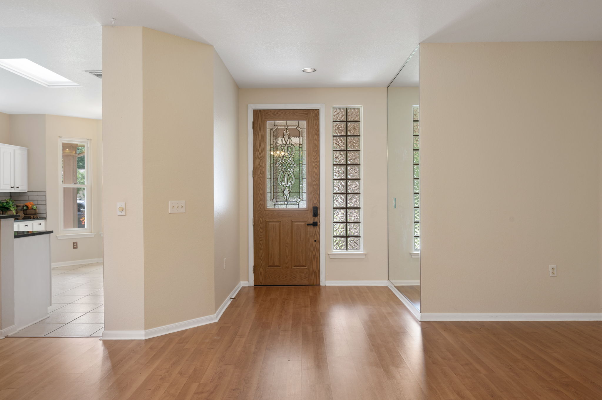 118 Bass Street Georgetown, TX 78633 - Photo 9 of 40 Enter into a light-filled space featuring warm wood flooring and a beautiful leaded glass entry door.