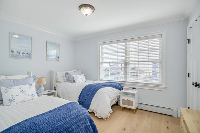 a bedroom with two beds and a window