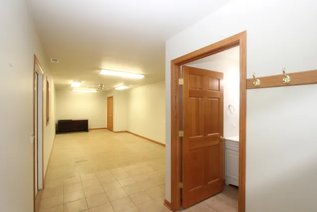 a view of a hallway with a bathroom