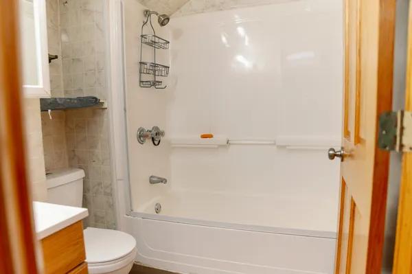 a bathroom with a toilet and a shower