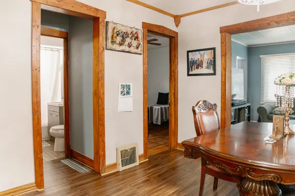a dining room with furniture and wooden floor