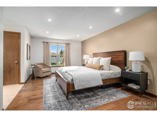 a bedroom with a bed a couch and dresser