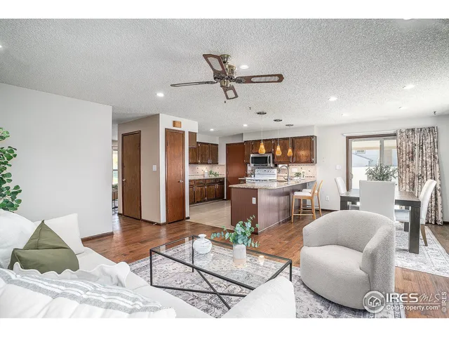 a living room with furniture and kitchen view