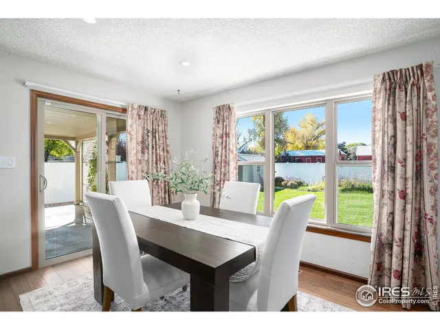 a dining room with furniture window and outside view