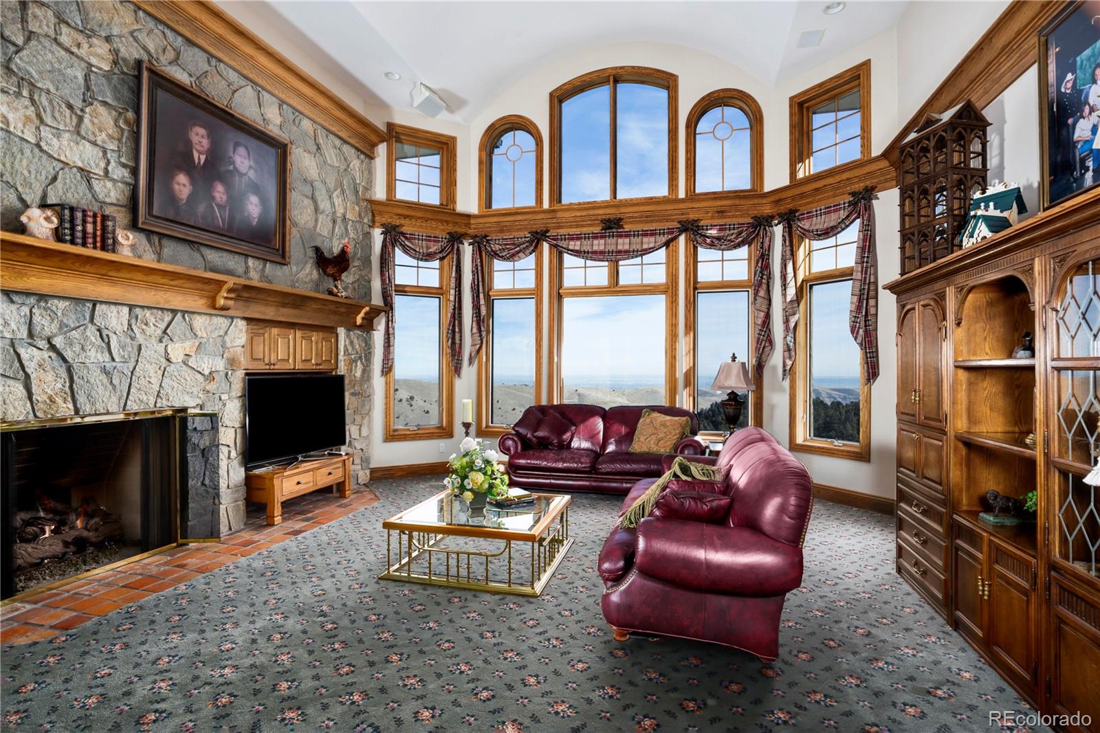 1334 South Grapevine Road Golden, CO 80401 - Photo 12 of 36 a living room with furniture a fireplace and a flat screen tv