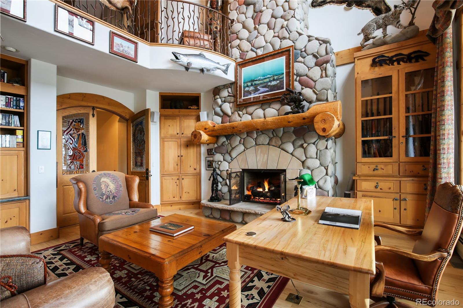 1334 South Grapevine Road Golden, CO 80401 - Photo 15 of 36 a living room with furniture a fireplace and a flat screen tv