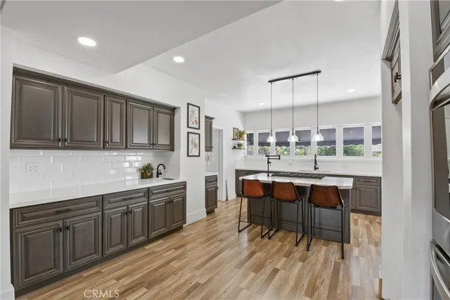 a kitchen with sink cabinets and wooden floor