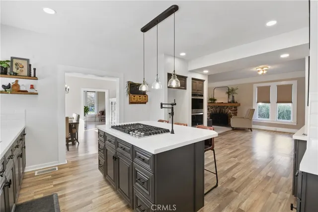 a kitchen that has a stove a table and chairs in it