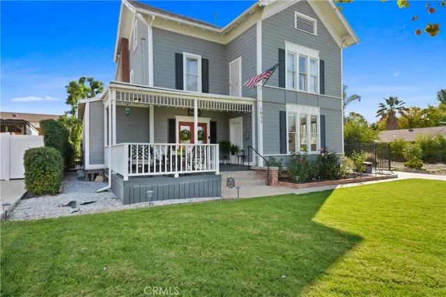 a view of a house with a yard and deck