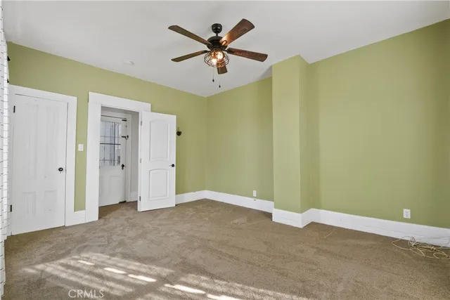 a view of a livingroom with a ceiling fan & a ceiling fan