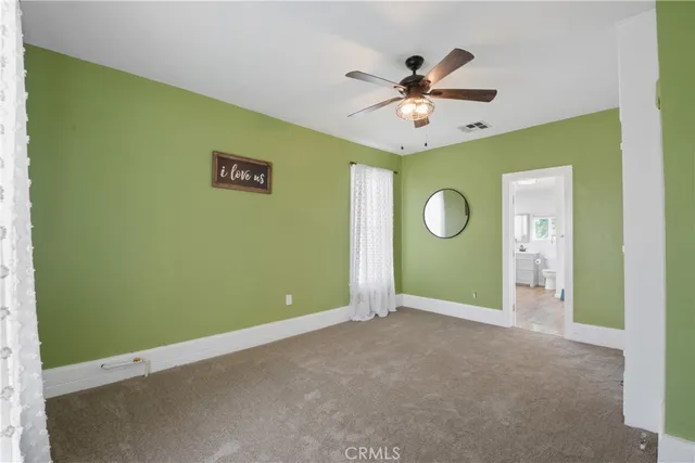 a view of a livingroom with a ceiling fan and wooden floor