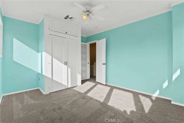 a view of a big room with closet and windows