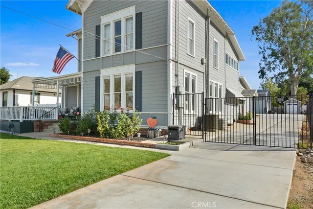 a front view of a house with a garden and plants