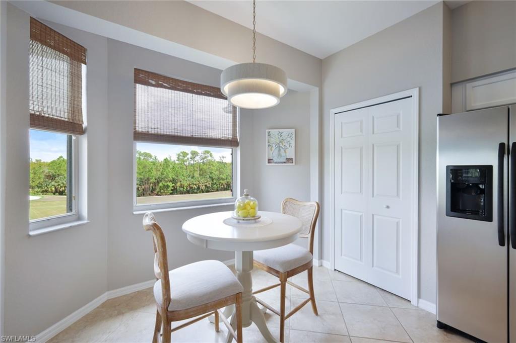10329 Heritage Bay Boulevard, Unit 1641 Naples, FL 34120 - Photo 12 of 22 Dining space featuring light tile patterned floors and baseboards