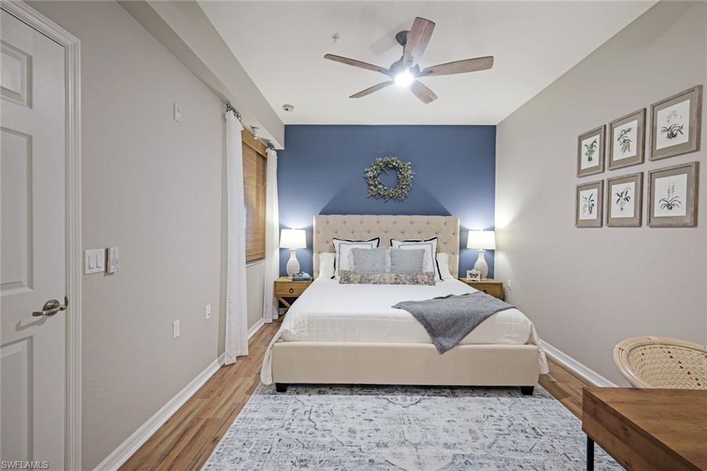 10329 Heritage Bay Boulevard, Unit 1641 Naples, FL 34120 - Photo 16 of 22 Bedroom featuring wood finished floors, baseboards, and a ceiling fan