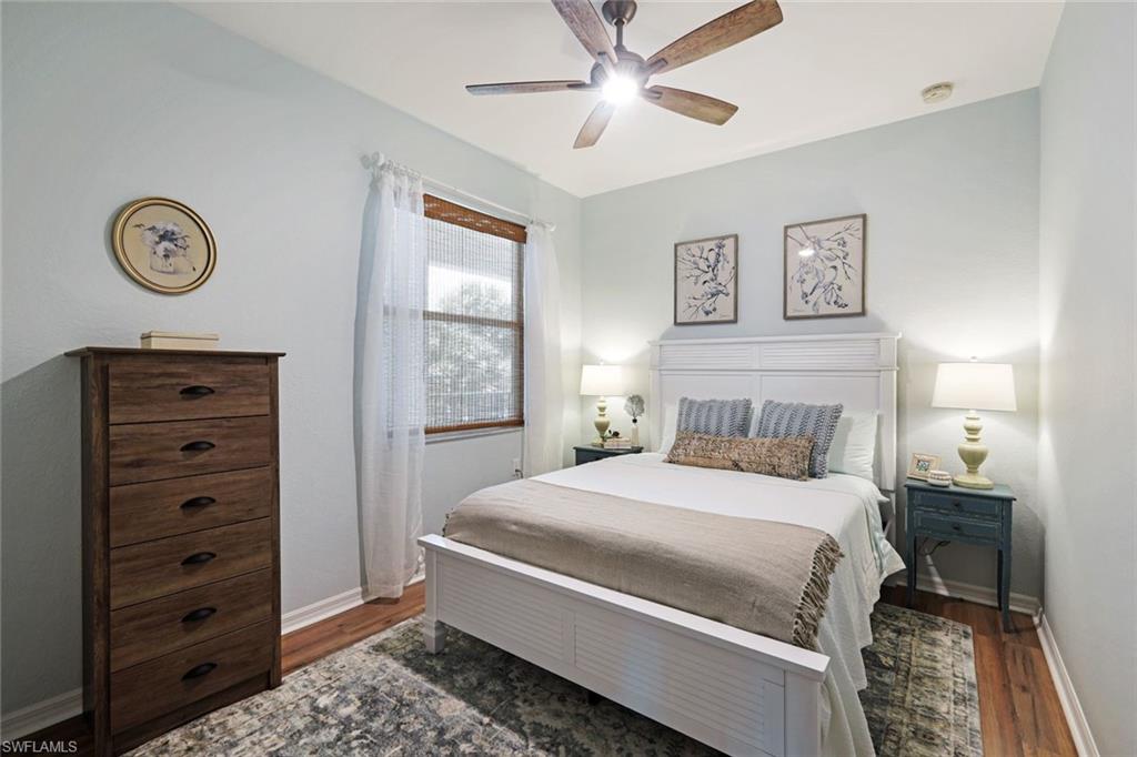 10329 Heritage Bay Boulevard, Unit 1641 Naples, FL 34120 - Photo 18 of 22 Bedroom featuring wood finished floors, baseboards, and ceiling fan