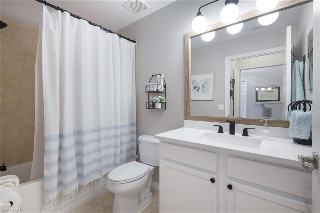 10329 Heritage Bay Boulevard, Unit 1641 Naples, FL 34120 - Photo 19 of 22 Bathroom featuring toilet, vanity, and shower / tub combo