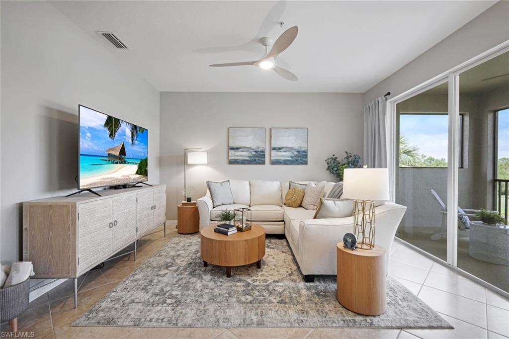 10329 Heritage Bay Boulevard, Unit 1641 Naples, FL 34120 - Photo 3 of 22 Tiled living room with ceiling fan