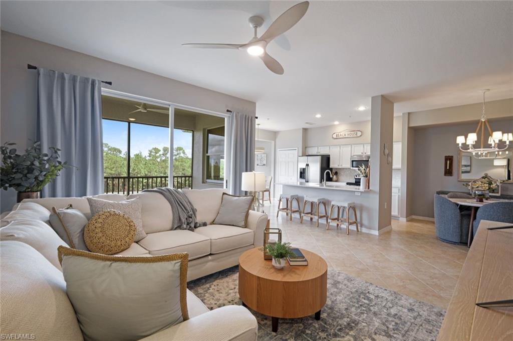 10329 Heritage Bay Boulevard, Unit 1641 Naples, FL 34120 - Photo 5 of 22 Living area featuring a ceiling fan, a chandelier, light tile patterned floors, and recessed lighting