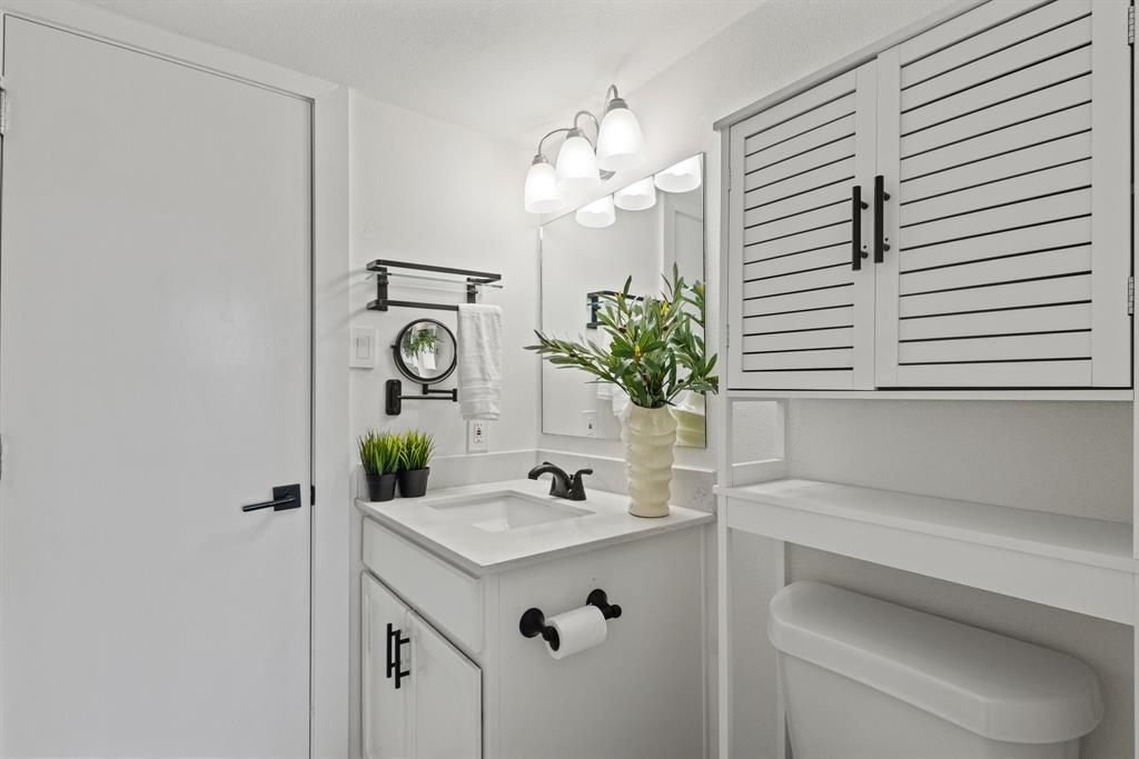 2806 Knight Street, Unit 103 Dallas, TX 75219 - Photo 13 of 17 a bathroom with a sink and a mirror
