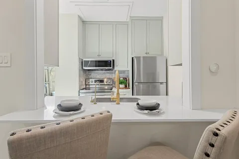 a kitchen with a sink and a refrigerator