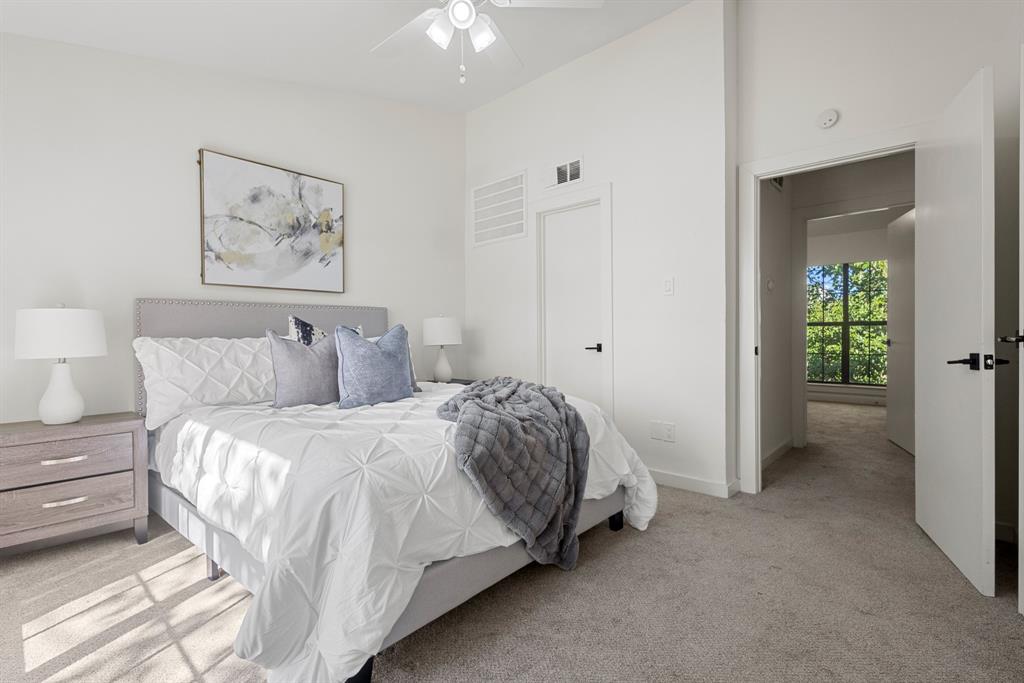 2806 Knight Street, Unit 103 Dallas, TX 75219 - Photo 9 of 17 a bedroom with a bed and a chandelier