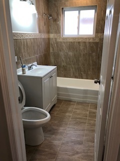 5204 State Road Burbank, IL 60459 - Photo 18 of 30 a bathroom with a sink a toilet and shower