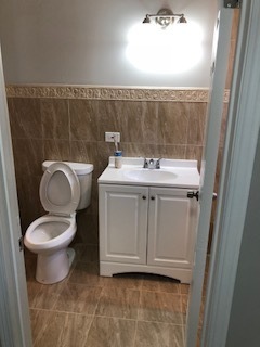 5204 State Road Burbank, IL 60459 - Photo 19 of 30 a bathroom with a granite countertop toilet and a sink